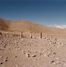 The main row of pillars. The proximate rectangular structure is visible immediately left of the main row of pillars. On the left side of the image some of the minor standing stones of the site can be made out.