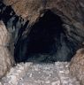 Wall footings lining each side of the forward portion of the cave.