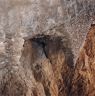 An elevated masonry cell in the cave’s façade.