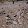 Measuring funerary structure FS2. Note the coherent double-course wall fragment.