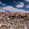 The east and south sides of the site. Note the white chöten (<i>mchod rten</i>)-like tsatsa (<i>tshwa tshwa</i>) receptacle in the background.