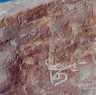 A close-up of the old swastika carving and the much more recently engraved letter <i>a</i>.