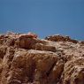 A defensive wall rising above the summit of the formation.