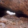 The northwest mouth of the cave, with its massive masonry front. The south mouth of the cave is visible in the distance.