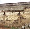 Old wall in Lha klu neighborhood with layer of sod used as construction material. 2002.