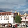 Main Jokhang entrance, with seventh-century Wönzhang Pillar (<i>rdo ring</i>) visible against the white wall at lower left.