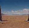 The site’s two rooted pillars. Note the sacred Bon lake Gunggyü Tso (<i>gung rgyud mtsho</i>) in the background.