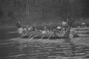 Architecture students paddling cardboard boat