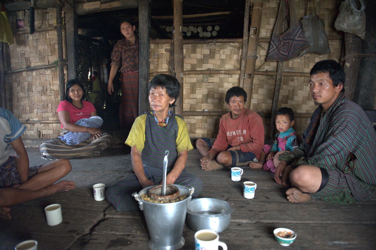 View of Bhutanese in a rural village drinking bangchang drink ...