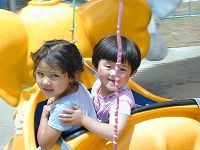 Young Tibetan girls on an amusement park ride.